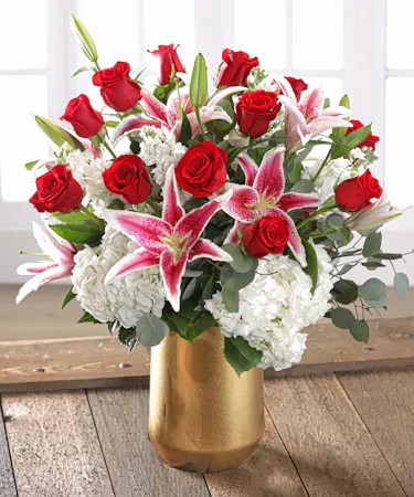 Wild About You Bouquet featuring a dozen red roses, white hydrangea, stargazer lilies and garden florals