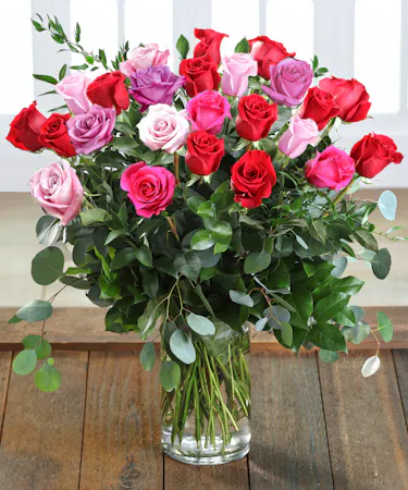 Farm-fresh luxury 'Love & Romance' Ecuadorian Mountain Roses featuring our 30% Larger Red, Pink, and Hot Pink Colors in a chic vase.
