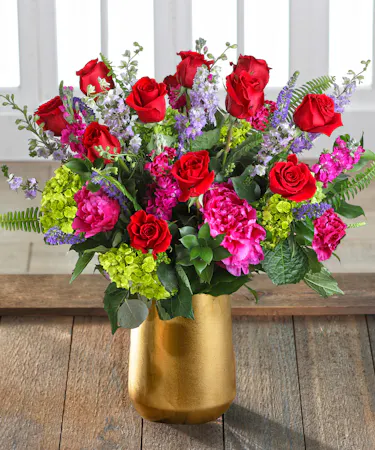 The Atlanta Rose Garden featuring one dozen Ecuadorian red roses and pink peony nestled in Southern blush hydrangea