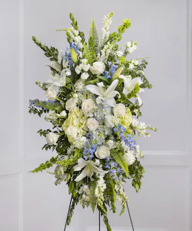 Blue & White Garden Sympathy Spray of hydrangea, snapdragons, delphinium on a standing easel