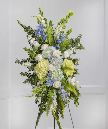 Blue & White Garden Sympathy Spray of hydrangea, snapdragons, delphinium on a standing easel