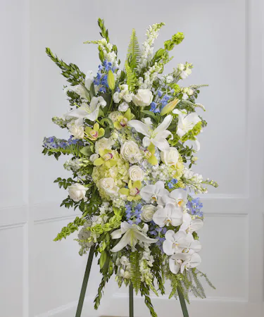 Blue & White Garden Sympathy Spray of hydrangea, snapdragons, delphinium on a standing easel