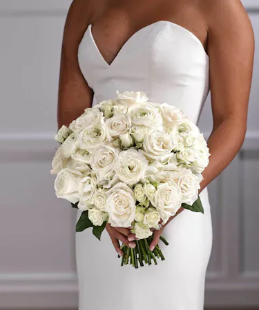 Bridal Bouquet of Hydrangea, White roses, White Ranunculus, White spray roses in classic pave style.