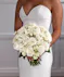 Bridal Bouquet of Hydrangea, White roses, White Ranunculus, White spray roses in classic pave style.