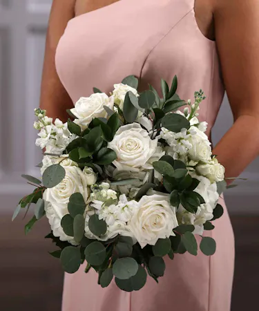 Bridesmaid White Loose Pave Style Bouquet of hydrangea, roses, stock and eucalyptus.