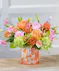 The Citrus Pop features hydrangea, roses, lisianthus, hypericum berries and more in our orange confetti glass vase.