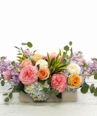 Pastel English garden table centerpiece featuring hydrangea, roses, veronica and ranunculus