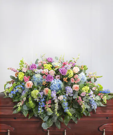 Pastel Garden Floral Casket Cover Blanket featuring hydrangea, roses, delphinium, snapdragons and seasonal foliage.