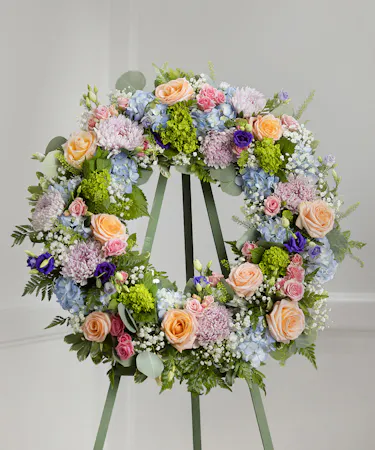 Elegant Pastel Garden Sympathy Wreath featuring pastel farm-fresh flowers on a standing easel