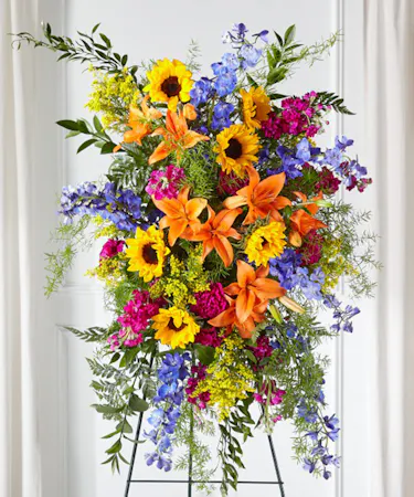The Sunlit Memories Standing Garden Spray features sunflowers,  stock, delphinium, and more.