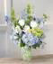 Summer Skies featuring blue hydrangea, roses, stock, bells of Ireland and orchids