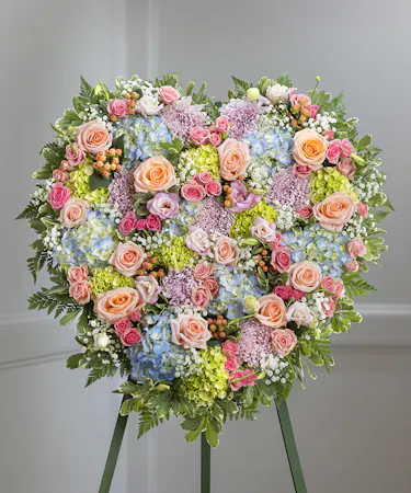 Pastel Garden Sympathy Floral Heart Arrangement on a standing easel