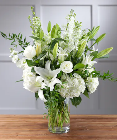 Elegant White Garden Vista featuring hydrangea, snapdragons, roses, lilies, stock and seasonal foliage