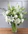 Elegant White Garden Vista featuring hydrangea, snapdragons, roses, lilies, stock and seasonal foliage