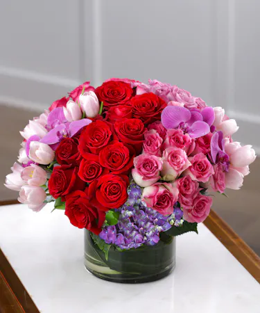 Timeless Glamour features fifty luxury roses, purple hydrangea and exotic orchids.
