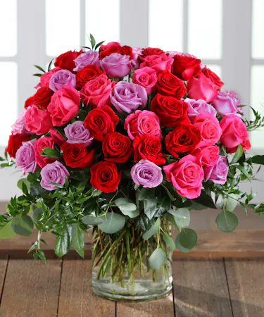 Farm-fresh luxury 'Love & Romance' Ecuadorian Mountain Roses featuring our 30% Larger Red, Pink, and Hot Pink Colors in a chic vase.