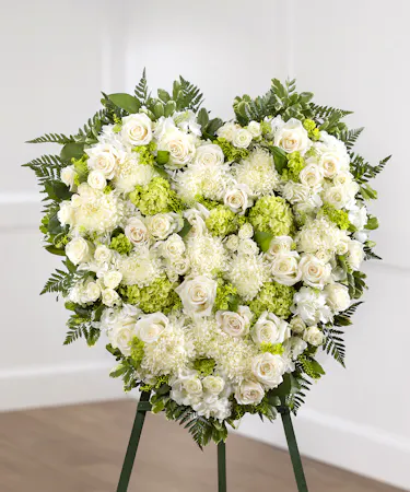 White garden sympathy heart design on a standing easel