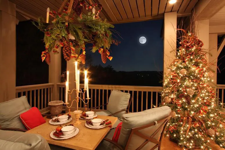 Outdoor Porch decorated for Christmas. Garland, Mantle, Candles, by Carithers Flowers
